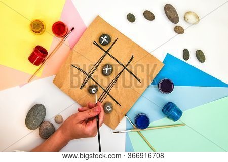 Top View Of Tic Tac Toe Game With Stones Marked With Naughts And Crosses. Childrens Art Project, A C