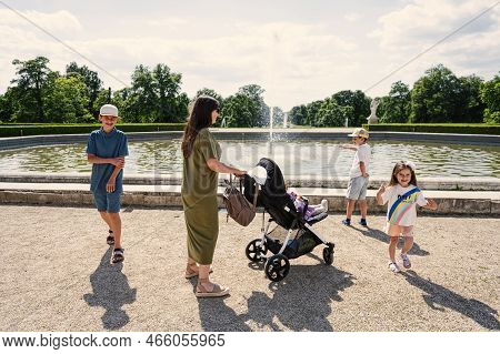 Mother With Kids Near Fountain Of Slavkov Castle, Also Known As Austerlitz Castle, Is A Baroque Pala