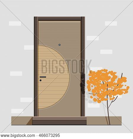 The Entrance Door Is Brown In Color With A Curved Linear Element, A Handle And A Peephole And A Lock