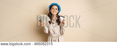 Microcredit And Money Concept. Young Stylish Woman Showing Credit Card And Dollars Cash, Smiling Hap