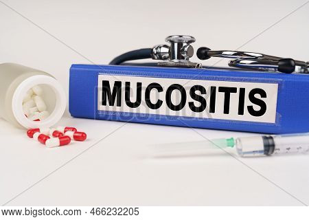 Medical Concept. On A White Surface There Are Pills, A Syringe, A Stethoscope And A Folder With The 
