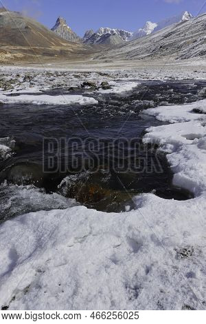 Frozen Mountain Stream Flowing Through The Scenic Alpine Valley At Yumesodong Or Zero Point, The Bea
