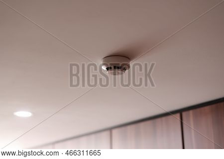 Fire System Indoors. White Smoke Detector Issue A Signal To A Fire Alarm Control Panel As Part Of A 
