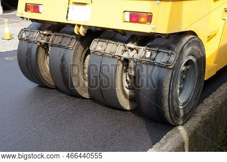 Pneumatic Roller Of Tires Compacting New Asphalt Of A Street. Repaving The Road Surface. Road Works