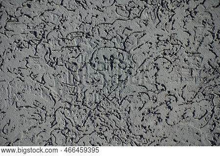 Closeup Of Dark Gray Wall With Stucco Worm Finish