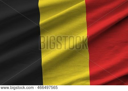 Belgium Flag With Big Folds Waving Close Up Under The Studio Light Indoors. The Official Symbols And
