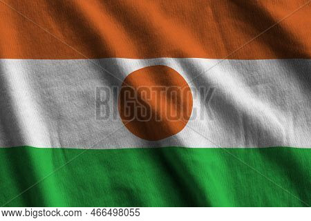Niger Flag With Big Folds Waving Close Up Under The Studio Light Indoors. The Official Symbols And C