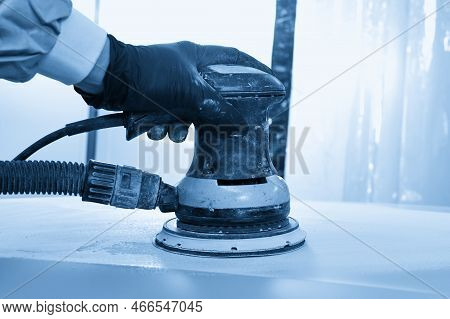 Auto Mechanic Buffing And Polishing Car In Auto Repair Shop With Orbital Polisher, Basic Layer Clean