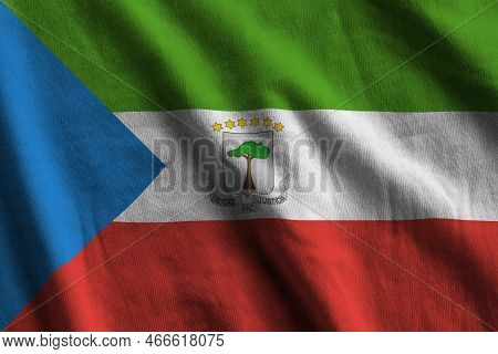 Equatorial Guinea Flag With Big Folds Waving Close Up Under The Studio Light Indoors. The Official S