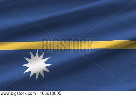 Nauru Flag With Big Folds Waving Close Up Under The Studio Light Indoors. The Official Symbols And C