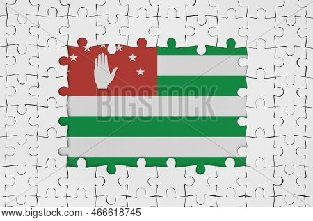 Abkhazia Flag In Frame Of White Puzzle Pieces With Missing Central Parts