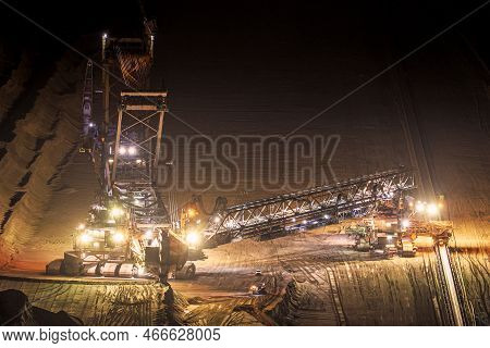Heavy Mining Equipment At Work In An Open-pit Mine At Dusk.