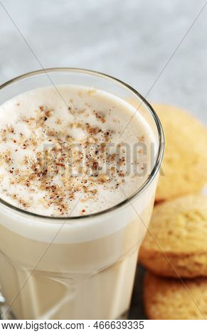Coffee With Milk And Grated Nut In A Glass Close-up. Raff Coffee.