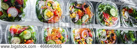 Boxes With Pre-packaged Vegetable Salads In A Commercial Fridge