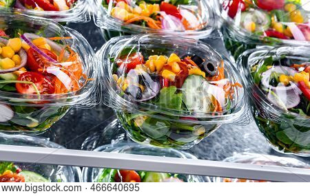 Boxes With Pre-packaged Vegetable Salads In A Commercial Fridge