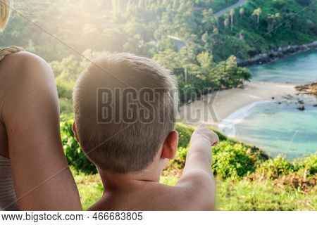 Back View Of Little Boy Sitting With Mom And Looking At Beautiful Tropical Yanui Beach. Phuket Islan