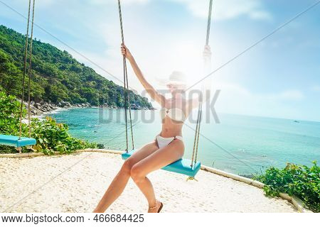Happy Woman In White Bikini Swinging On Tropical Beach, Hot Sunny Day. Relax. Summer Vibe. Island Li