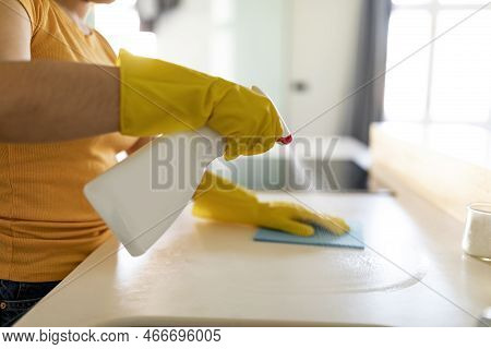 Ocd Concept. Woman With Sprayer And Rag Cleaning Kitchen Counter