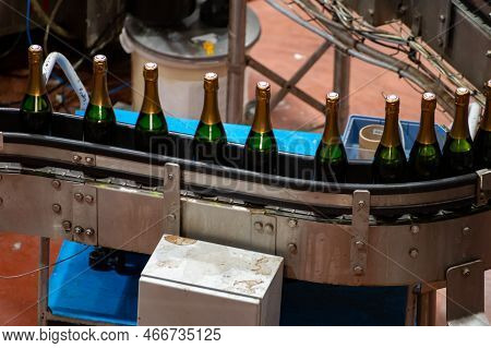 Production Of Cremant Sparkling Wine In Burgundy, France. Automatically Powered Bottling Lines On Fa