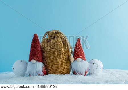 Christmas Or Winter Composition. Two Gnomes With A Bag Of Gifts In The Snow. Christmas, Winter, New 