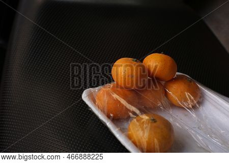Jeruk Santang Madu (citrus Sinensis) Served In White Styrofoam With Black Background. Free Space For