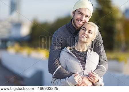 Closeup Of Two Embracing Positive Caucasian Runners Athletes Relaxing During Training Together And S