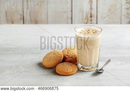 Coffee Raff In A Glass Close-up With Homemade Cookies. Coffee With Milk And Grated Nut On Light Back