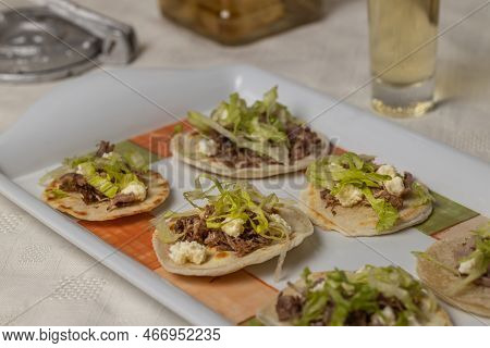 Close Up Of Chalupas, Typical Mexican Dish Made With Tortillas, Sauce, Cheese, Meat And Lettuce.