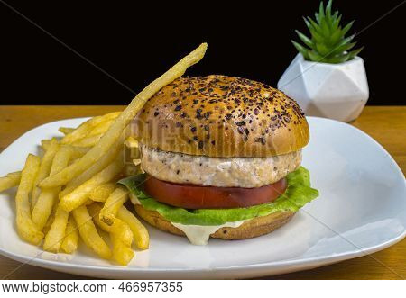Salmon Buger On A Everthing Bagel  And Served With Fries