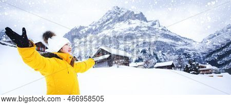 Grindelwald Switzerland Top Of Europe, Asian Woman Wearing Yellow Coat.she Is Feel Very Happy On Vac