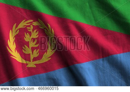 Eritrea Flag With Big Folds Waving Close Up Under The Studio Light Indoors. The Official Symbols And