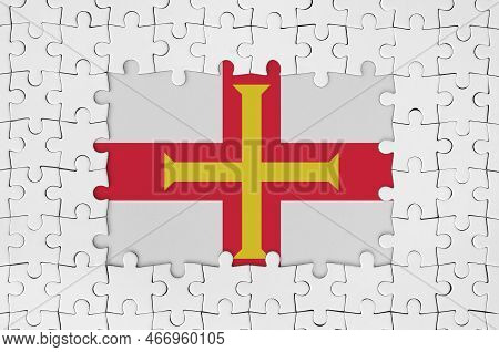 Guernsey Flag In Frame Of White Puzzle Pieces With Missing Central Parts