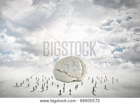 Huge human brain and many little businesspeople around