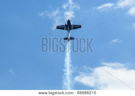 BERLIN, GERMANY - MAY 21, 2014: A Extra-300, D-EAXK- two-seat aerobatic plane (Germany), demonstration during the International Aerospace Exhibition ILA Berlin Air Show-2014.