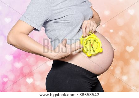 Pregnant Woman's Belly With Clock