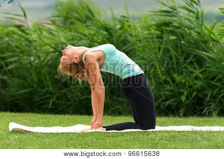 Young Woman Show Camel Yoga Pose