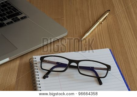 Glasses, Paper and Computer Keyboard