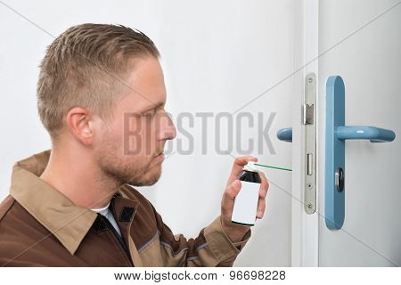Male Carpenter Lubricating Door