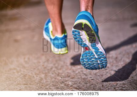Running athlete during training outdoors in the summer on a sunny day.