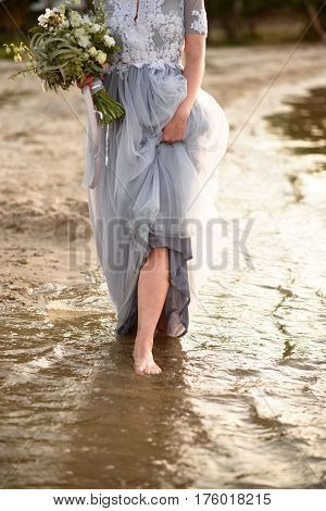 Young girl smiling. young beautiful girl walking. bride is resting at sunset. young beautiful girl in a dress. Close-up