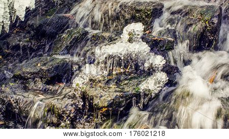 St. Petersburg-12.03.2017: stream with streaming water in winter with ice cubes and icicles