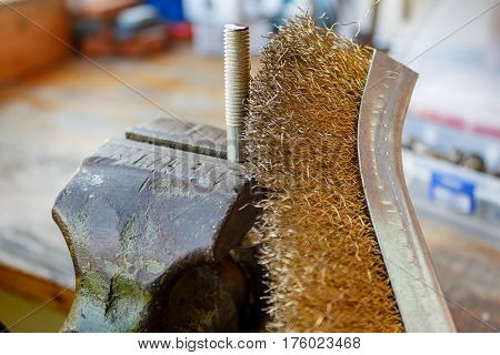 Clean the threads on the bolt with a wire brush