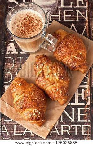 Breakfast with coffee and croissants on wooden  table