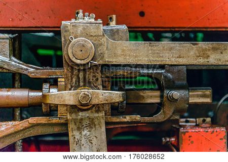 Closeup of greased and heavy mechanical parts of an old steam locomotive