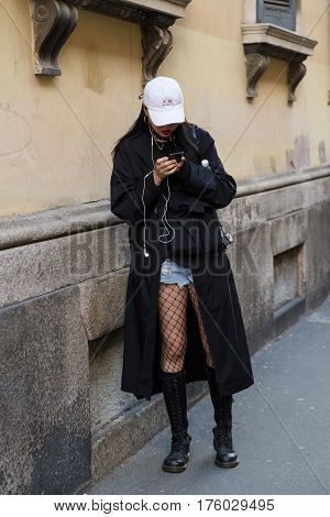 MILAN ITALY - FEBRUARY 25: Fashionable woman poses outside Blumarine fashion show during Milan Women's Fashion Week on FEBRUARY 25 2017 in Milan.