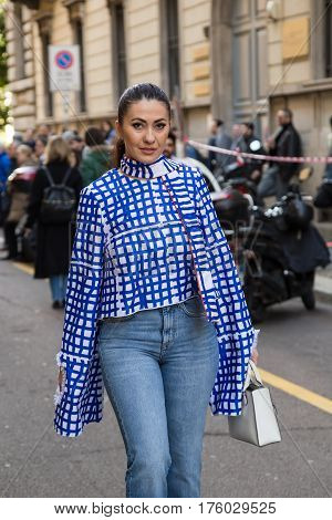 MILAN ITALY - FEBRUARY 25: Fashionable woman poses outside Blumarine fashion show during Milan Women's Fashion Week on FEBRUARY 25 2017 in Milan.
