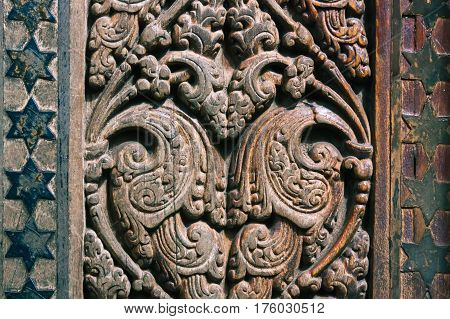 Beautiful wood carving on ancient door in Buddhist temple in Kandyon Sri Lanka.