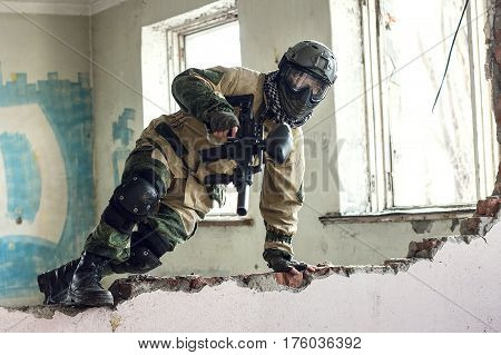 Shot of militaty man passing an obstacle with weapon