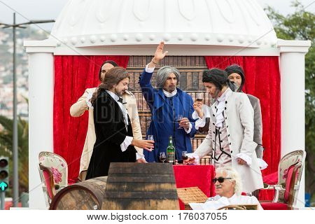 FUNCHAL MADEIRA PORTUGAL - SEPTEMBER 4 2016: Men in historical fashion dress raise toasts durnig historical and ethnographic parade of Madeira Wine Festival in Funchal. Madeira Portugal