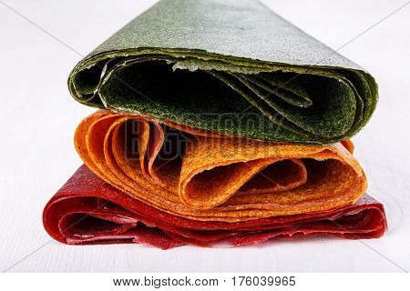 Tklapi - dried mashed fruit pulp / Colorful fruit leather from apricot kiwi dogwood. Georgian and Armenian cuisine.